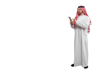 Male Arab with phone in hand isolated white background in traditional costume. Ready for cutting and editingの写真素材