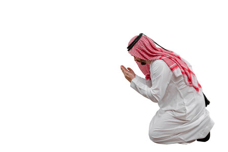 Male Arab praying, isolated white background in traditional costume. Ready for cutting and editingの写真素材