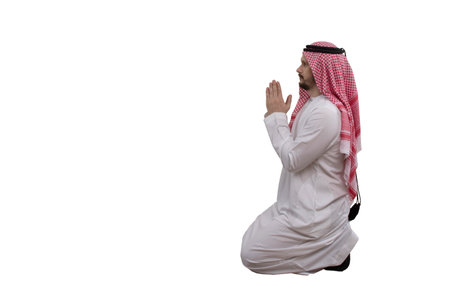 Male Arab praying, isolated white background in traditional costume. Ready for cutting and editingの写真素材