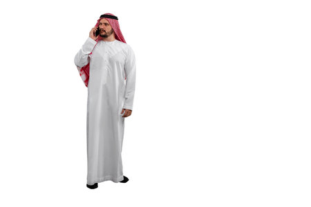 Arab man talking on phone isolated white background in traditional costume. Ready for cutting and editingの写真素材