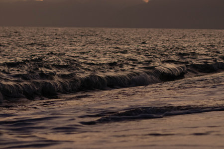 Beautiful view of the sea and mountains at sunsetの写真素材