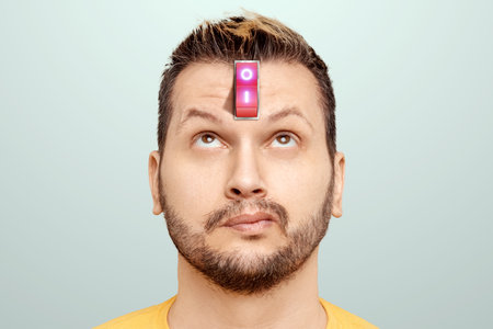 A businessman has a red switch in his head. The concept of turning on the power of the brain, turning off negative thoughts, turning on the thought process, generating ideasの写真素材