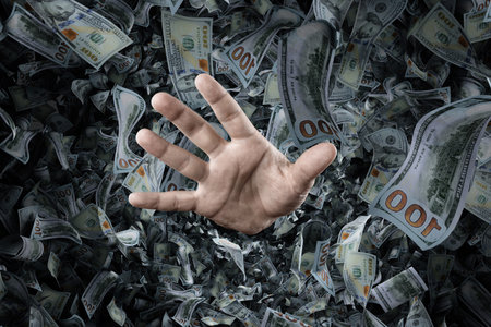 A businessman's hand is sticking out of a pile of dollars. Concept of winning the lottery, inheritance, investment, passive income. mixed mediaの写真素材