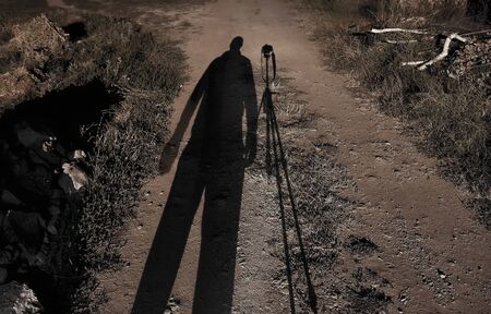 Self portrait with camera stand in the late evening.の写真素材