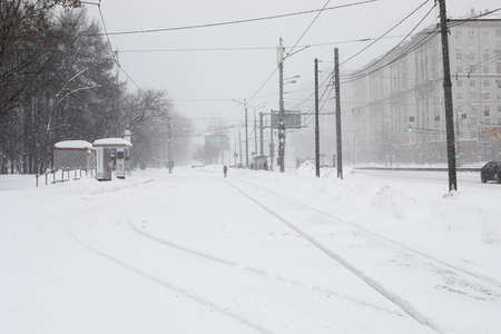 Moscow, Russia. 13th February 2021. A blizzard covered the city. Empty tram station under the snow with frozen tracks.のeditorial素材