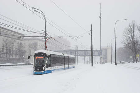 Moscow, Russia. 13th February 2021. A blizzard covered the city. Tram is going under the snowのeditorial素材