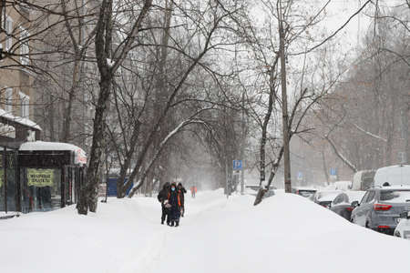 Moscow, Russia. 13th February 2021. A blizzard covered the city. People are walking on the snow in a cold weatherのeditorial素材
