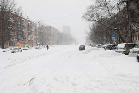Moscow, Russia. 13th February 2021. A blizzard covered the city. Few people on a frozen and lonely street.のeditorial素材