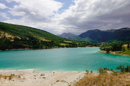 Panorama of the Fiastra Lake on the Sibillini Mountains in Marche. Italy. Dark clouds ae coming.の写真素材