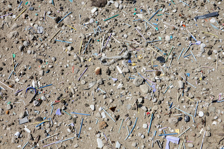 Dirty beach full of plastic, microplastic, bottles, straws and various garbage.の写真素材
