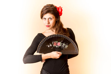 Girl posing with a  fanの写真素材