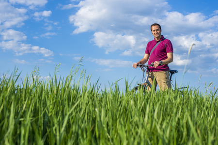 Young man enjoing a ride on a bikeの写真素材