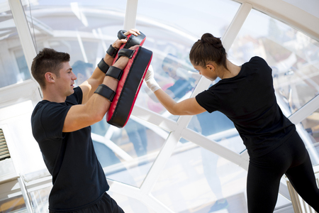 Young girl exercise punching with her coachの写真素材