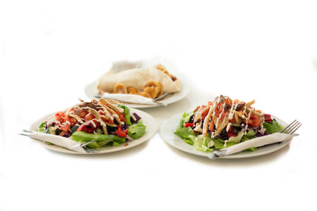 Tortilla and two delicious salads served on a tableの写真素材