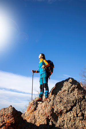 Beautiful female feeling the sun on her face in the mountainsの写真素材