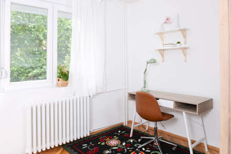 Small cozy workspace in a renovated apartmentの写真素材