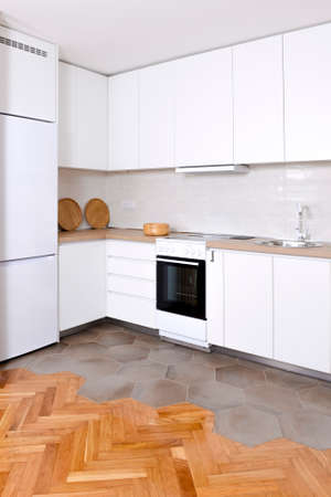 Luxurious and modern kitchen interior in white color with wooden elementsの写真素材