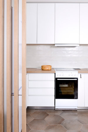 Luxurious and modern kitchen interior in white color with wooden elementsの写真素材
