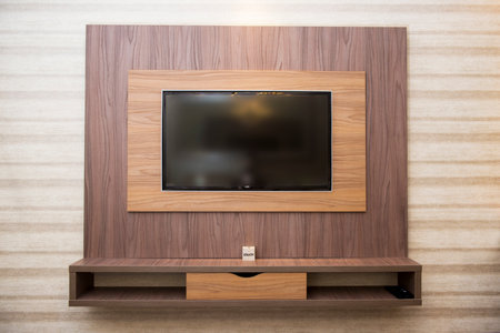 Smart TV in a wooden wall in a cozy apartmentの写真素材