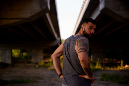 Young modern man with beard exercising outdoors in the streets to avoid crowding inside due to pandemic problemsの写真素材