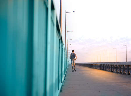 Young man training alone outside in a open safe areaの写真素材