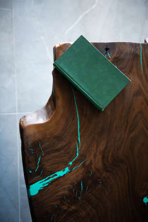 Green book with blank hardcover on a luxurious wooden custom made tableの写真素材