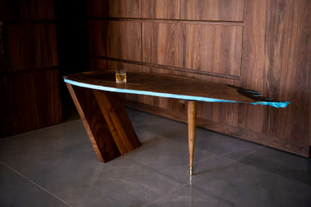 Unique hardwood table with a glass of whiskeyの写真素材