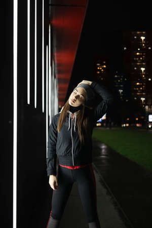 Female stretching her neck before her outdoor trainingの写真素材