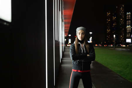 The woman prepares for a night run around the cityの写真素材