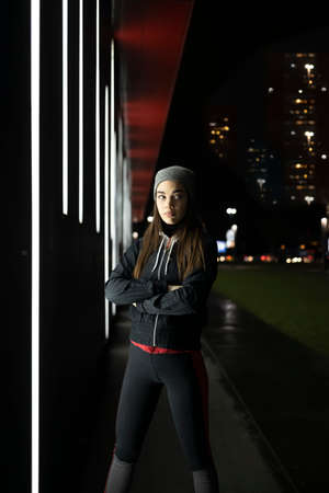 The woman prepares for a night run around the cityの写真素材