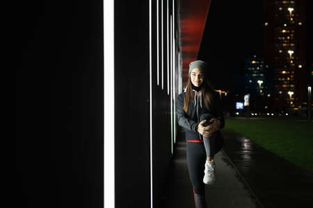 Female stretching her legs before her outdoor trainingの写真素材