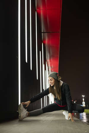 Female stretching her legs before her outdoor trainingの写真素材