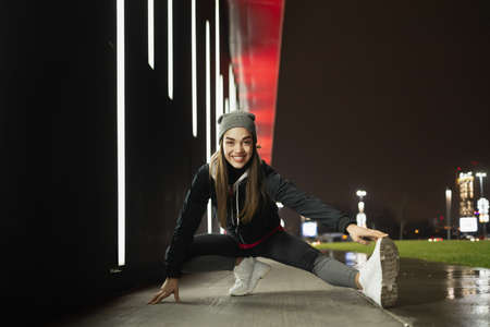 Female stretching her legs before her outdoor trainingの写真素材
