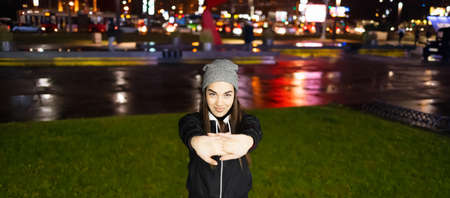 Female stretching her hands before her outdoor training in a big cityの写真素材
