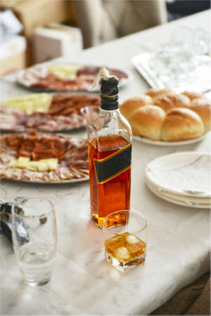 Glass and bottle of whiskey on the tableの写真素材