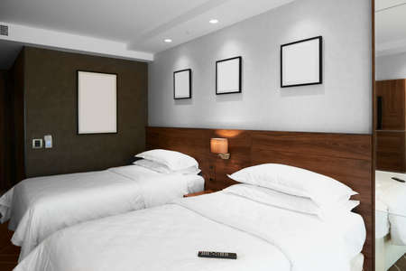 Modern bedroom interior with blank pictures on the wallの写真素材