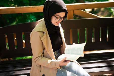 Beautiful Muslim woman researching a project in the parkの写真素材