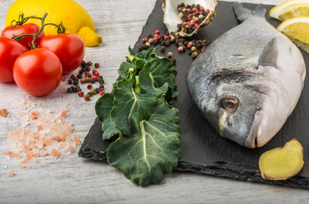 Useful dorado fish, rich in protein, vitamins, Omega 3 with vegetables, lemon and ginger, prepared...