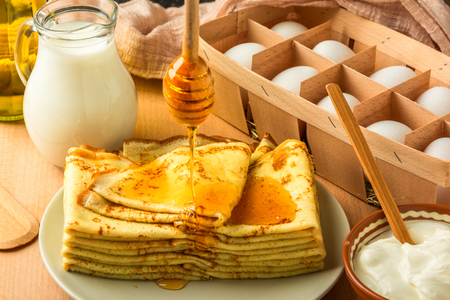ingredients for making pancakes and pancakesの写真素材