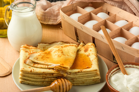 ingredients for making pancakes and pancakesの写真素材