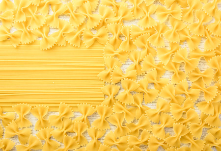 Italian raw pasta on a white surface. Top view, copy space.の写真素材