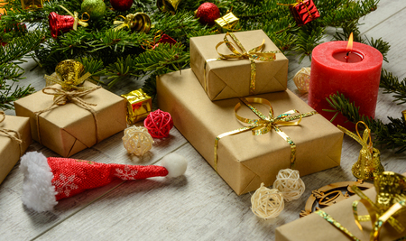 Christmas festive card with fir branches and festive decor on the white wood backgroundの写真素材
