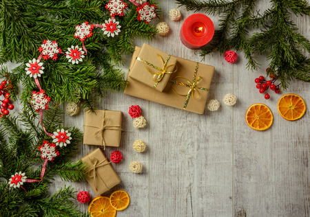 Christmas festive card with fir branches and festive decor on the white wood background. Flat lay.  Space for an object.の写真素材