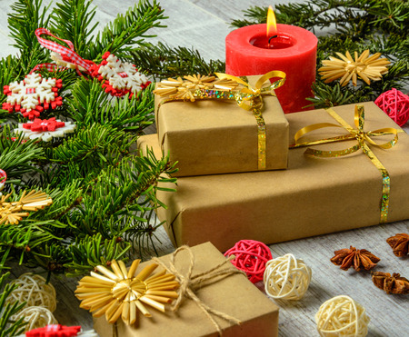 Christmas festive card with fir branches and festive decor on the white wood backgroundの写真素材