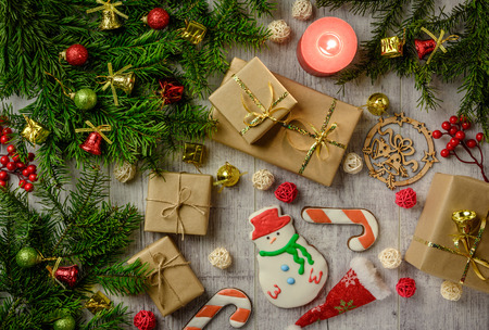 Christmas festive card with fir branches and festive decor on the white wood background. Flat lay.の写真素材