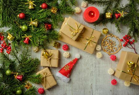Christmas festive card with fir branches and festive decor on the white wood background. Flat lay.  Space for an object.の写真素材