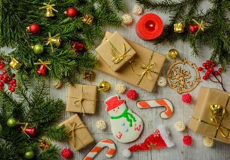 Christmas festive card with fir branches and festive decor on the white wood background. Flat lay.の写真素材