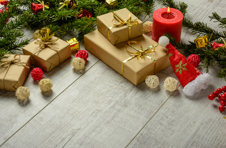 Christmas festive card with fir branches and festive decor on the white wood background.  Space for an object.の写真素材