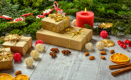 Christmas festive card with fir branches and festive decor on the white wood background.  Space for an object.の写真素材