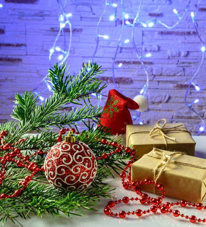 Christmas festive card with fir branches, gift box and festive decor on the  background with Christmas lights.の写真素材